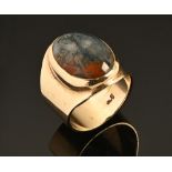 A 9 ct gold ring with inset oval moss agate, gross weight 8.9 grams.