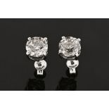 A pair of 18 ct white gold stud earrings, set with diamonds weighing +/- 4.02 carats.