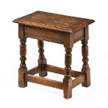 An oak joint stool with moulded edge, and scratch moulded frieze with turned legs and stretchers.