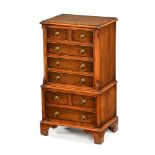 A George III style walnut dwarf tallboy,