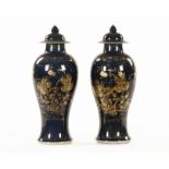 A pair of 19th century Chinese lidded vases, decorated with gilt chrysanthemum. Height 34 cm.