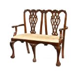An Edwardian Chippendale style mahogany chair back settee,