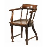 A Victorian oak office armchair, with simple spindle turned back supports,