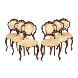 A set of six Victorian walnut dining chairs,