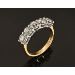 An 18 ct gold five stone half eternity ring, set with diamonds weighing +/- 2.