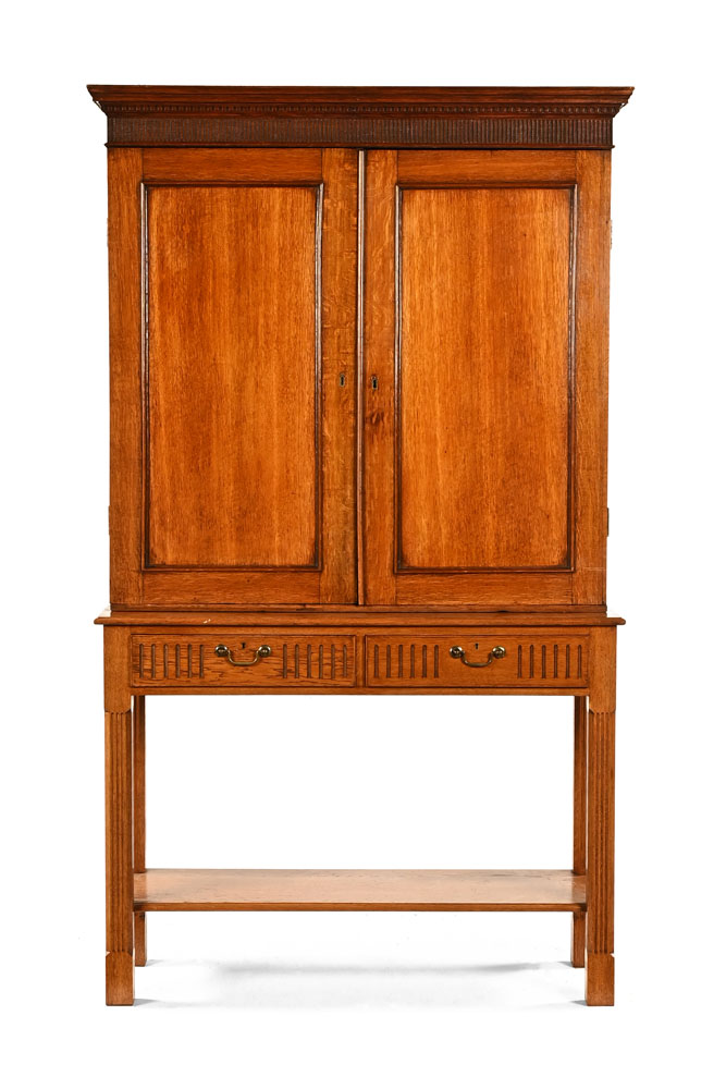 A George III oak cupboard, with moulded dentil cornice above a pair of doors enclosing shelves,