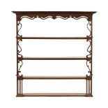 An oak delft rack, with dentil cornice above a fretwork frieze and sides and series of open shelves.