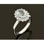 An 18 ct white gold aquamarine and diamond cluster ring, aquamarine +/- 2.5 carats, diamonds +/- .