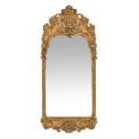 An early 20th century giltwood and gesso wall mirror, with shell and scroll mouldings to the frame.