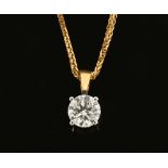 An 18 ct two tone gold pendant on chain, set with a diamond weighing +/- .60 carats.