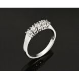 An 18 ct white gold five stone half eternity ring, set with diamonds weighing +/- .52 carats,size P.