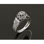 An 18 ct white gold diamond cluster ring. Size K/L. 5.3 grams.