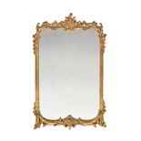 A gilt framed mirror, the moulded frame in the rococo style. Height 108 cm, width 65 cm.