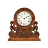 An Edwardian oak cased mantle clock, with single train movement complete with key.