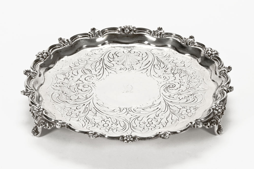 A William IV silver presentation salver, chased and crested London 1935, makers mark unclear.