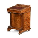 A Victorian walnut Davenport with fretwork gallery,