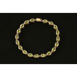 A 9 ct gold bracelet set with peridot.