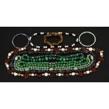 A collection of costume jewellery, including malachite necklace, tigers eye etc.