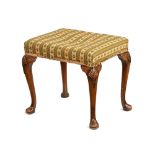 A Queen Anne style walnut footstool, with woolwork top bearing label Thomas Clarkson & Sons,