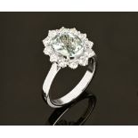 An 18 ct gold aquamarine and diamond cluster ring, aquamarine +/- 2.10 carats, diamonds +/- .