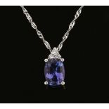 An 18 ct white gold pendant on chain, set with an oval cut tanzanite and diamonds. Tanzanite +/- 1.