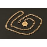 A 9 ct gold chain with yellow metal embossed decorated circular hair locket. 70 cm long.