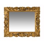 An antique Florentine gilt framed mirror, of rococo style. Frame dimensions 87 cm x 104 cm.