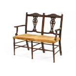 An Edwardian mahogany two chair back settee,