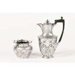 An Art Nouveau miniature silver plated jardinere and hot water jug. Tallest 22 cm.