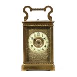 An Edwardian brass carriage clock, with repeat mechanism and two train movement striking on a gong.