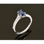 An 18 ct gold sapphire and diamond cluster ring, sapphire +/- 1.