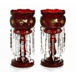 A pair of Victorian dark red and gilt decorated glass lustres, each 39 cm high (2).