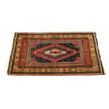 A Persian design rug, with centre rectangular panel and multiple line border,