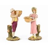 A pair of Worcester figures, each holding a basket, green printed mark. Height 25.5 cm.