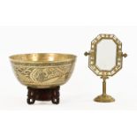 A Chinese bronze bowl on stand, together with a brass framed mirror. Bowl diameter 30 cm.