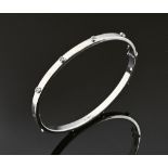 A 9 ct white gold bangle, set with small clear stones. 6.5 grams gross.