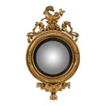 A Regency gilt framed oval wall mirror, with mythical horse cresting and foliate decoration.