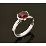 A platinum ring, set with a single ruby, hallmarked. Size N/O.