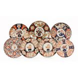 A collection of seven Japanese Imari porcelain plates, Meiji period, six with fluted designs,