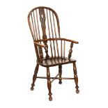 A 19th century Windsor armchair, with pierced splat back and solid shaped seat.