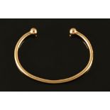 A 9 ct gold bangle. 14.6 grams.