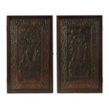 A large pair of antique Chinese carved wooden panels, depicting a table,