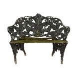 A cast iron garden seat, fern patterned with wooden slat seat.