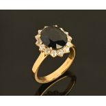 An 18 ct gold sapphire and diamond cluster ring, sapphire +/- 4.85 carats. Size N/O.