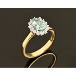 An 18 ct gold aquamarine and diamond cluster ring, aquamarine +/- 1.96 carats, diamonds +/- .