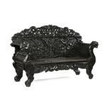 A large Oriental carved wooden hall bench, carved with dragons, with scroll arms,