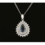 An 18 ct white gold pendant on chain, set with a pear shaped sapphire to double diamond halo.