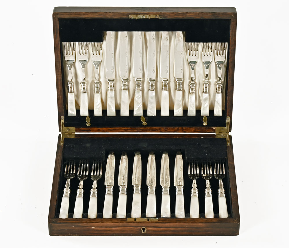 A cased set of twelve silver plated dessert knives and forks with mother of pearl effect handles.