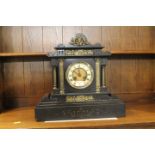 Ornate slate mantle clock, decorated with brass cherubs,
