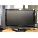 Small flat screen E-Motion TV with built in DVD player and remote control